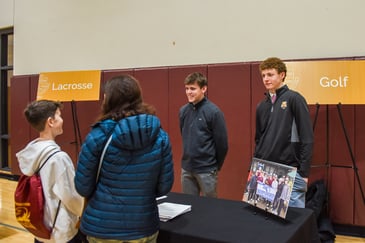 Parent and son at an open house event for BC High